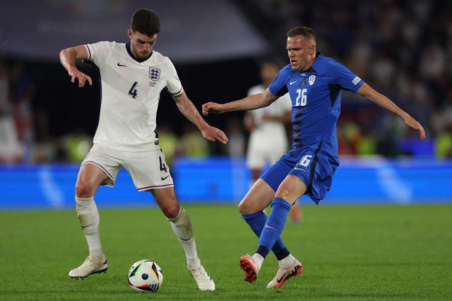 England midfielder Declan Rice fights for the ball with Slovenia midfielder Josip Ilicic
