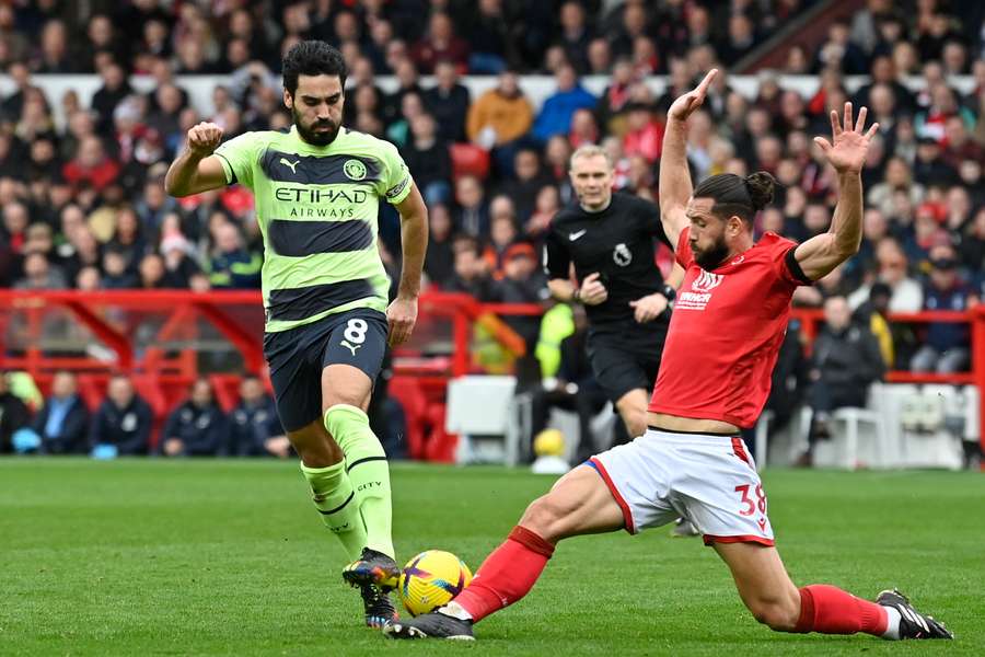 Ilkay Gundogan vies for the ball against Felipe