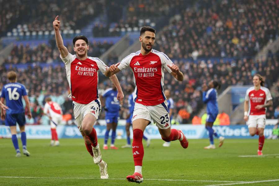 Mikel Merino celebrates scoring their first goal with Declan Rice