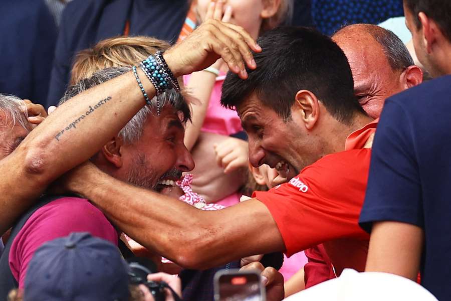 Goran Ivanisevic and Novak Djokovic embrace after the Serb's 23rd Grand Slam victory