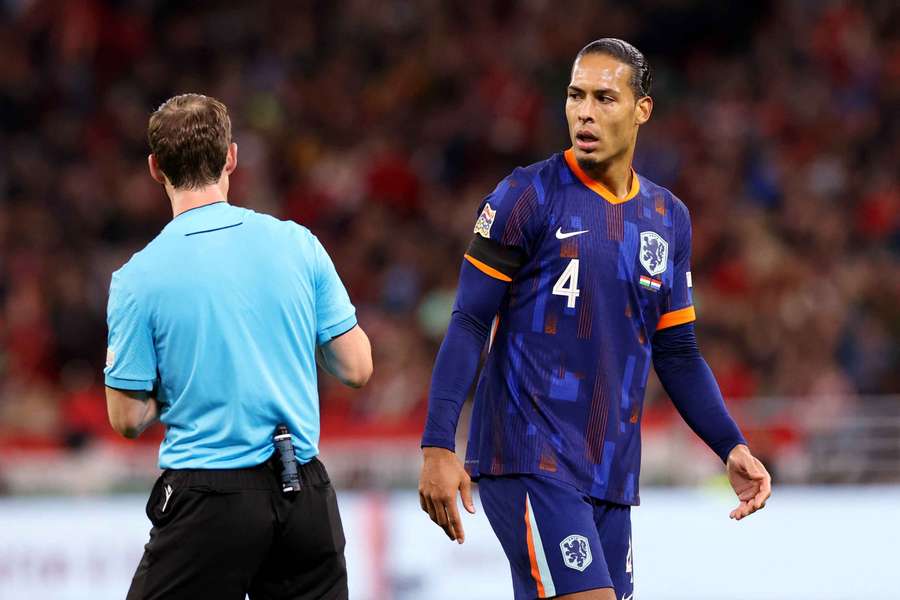 Netherlands captain Virgil van Dijk talks to the referee Lukas Fahndrich before being sent off