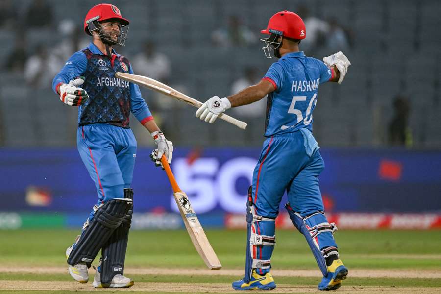 Afghanistan's Azmatullah Omarzai (L) celebrates with captain Hashmatullah Shahidi