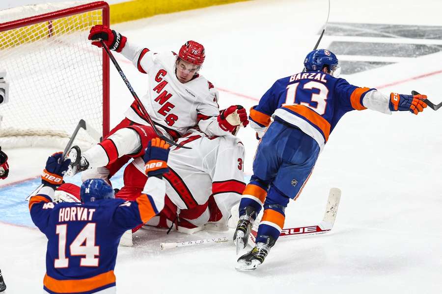 New York Islanders centre Mathew Barzal skates towards his teammates after scoring the game-winning goal