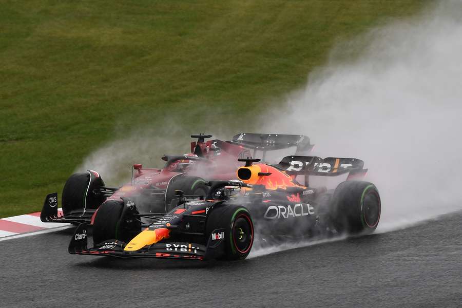 Red Bull Racing's Max Verstappen (R) and Ferrari's Charles Leclerc go side by side