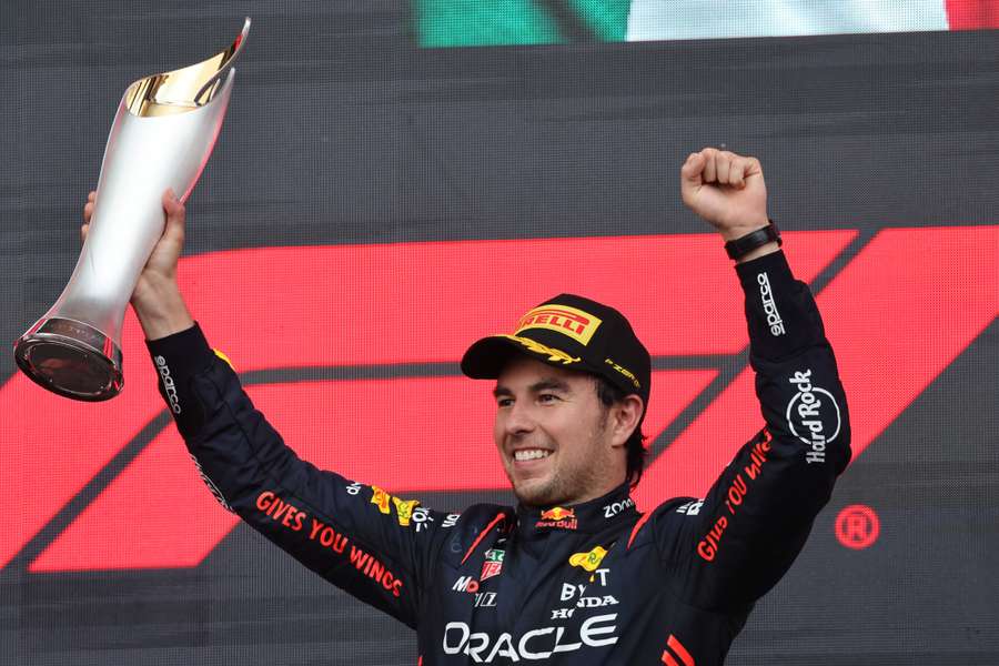 Red Bull Racing driver Sergio Perez celebrates with the trophy