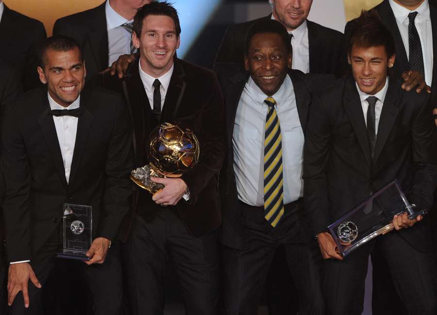 In this file photo taken on January 9, 2012, Barcelona's Argentinian forward Lionel Messi celebrates his third Ballon D'Or with Pele and Neymar