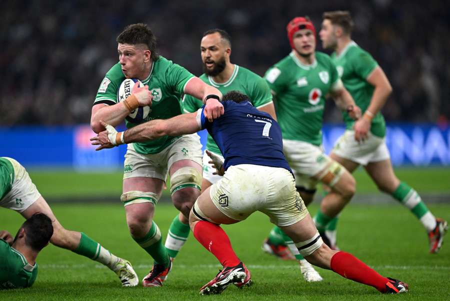 Joe McCarthy of Ireland is tackled by Charles Ollivon of France