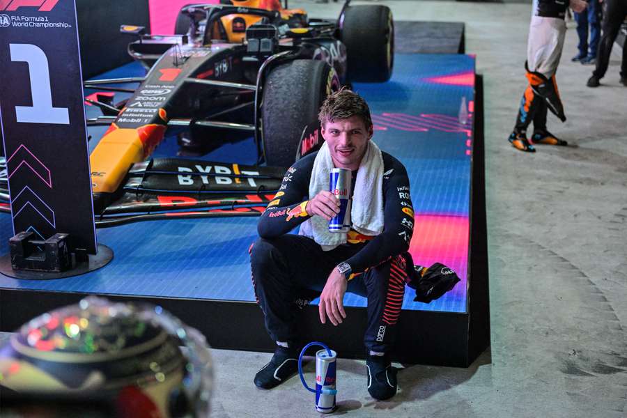 Red Bull Racing's Dutch driver Max Verstappen sits next to his car after winning