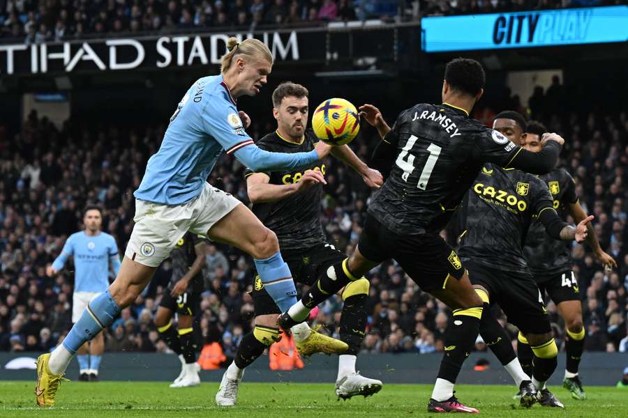 Erling Haaland storms through the Aston Villa defence in the first half