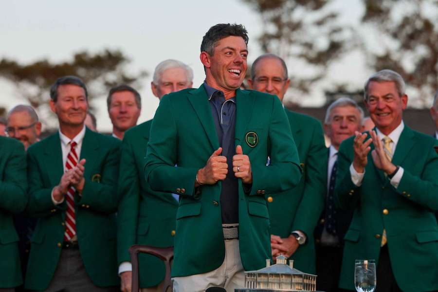 Rory McIlroy reacts as he puts on the Green Jacket after winning the 2025 Masters