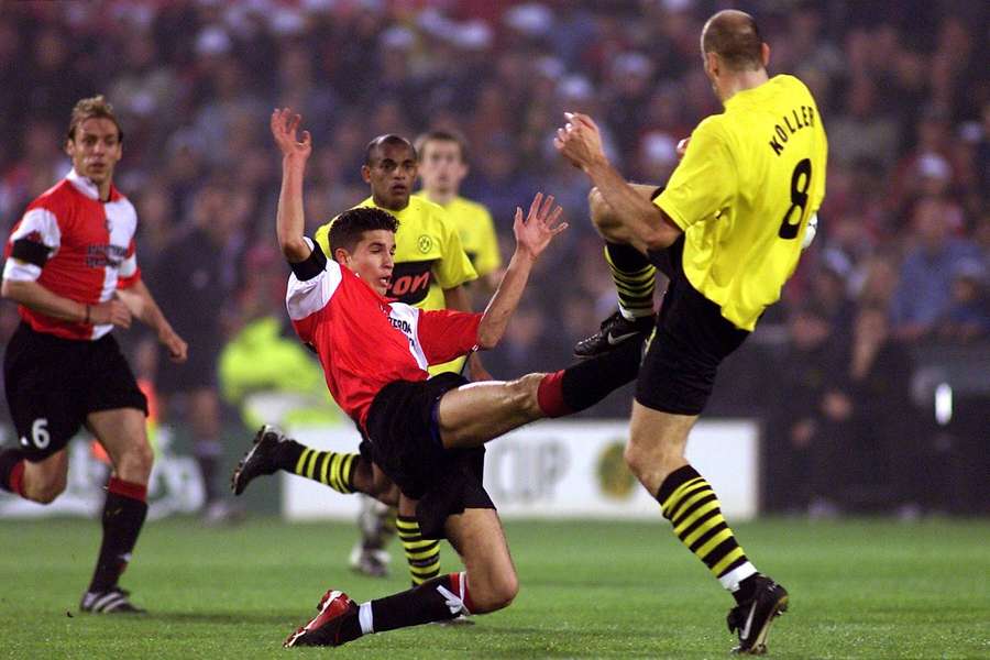 Robin van Persie battling for the ball with Borussia Dortmund's Jan Koller during the 2001/02 UEFA Cup final Robin van Persie battling for the ball with Borussia Dortmund's Jan Koller during the 2001/02 UEFA Cup final