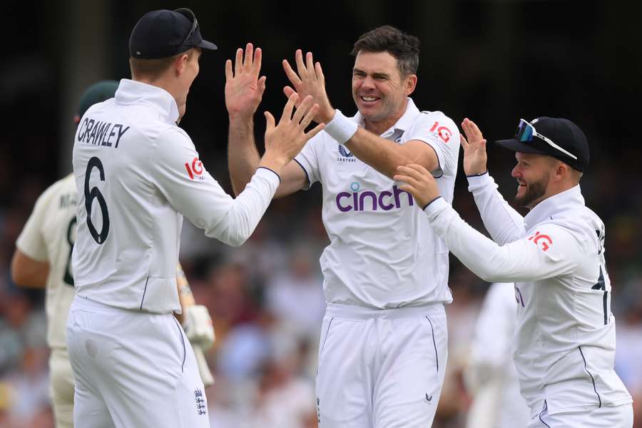 England's James Anderson (C) celebrates with teammates after bowling Australia's Mitchell Marsh on day two