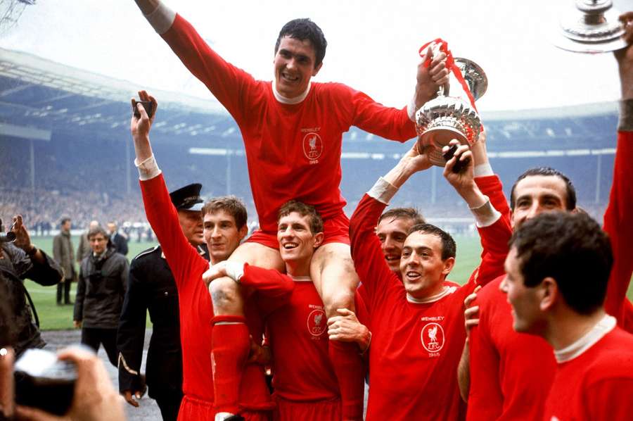 Ron Yeats (top) holds onto the FA Cup as he is hoisted aloft by teammates