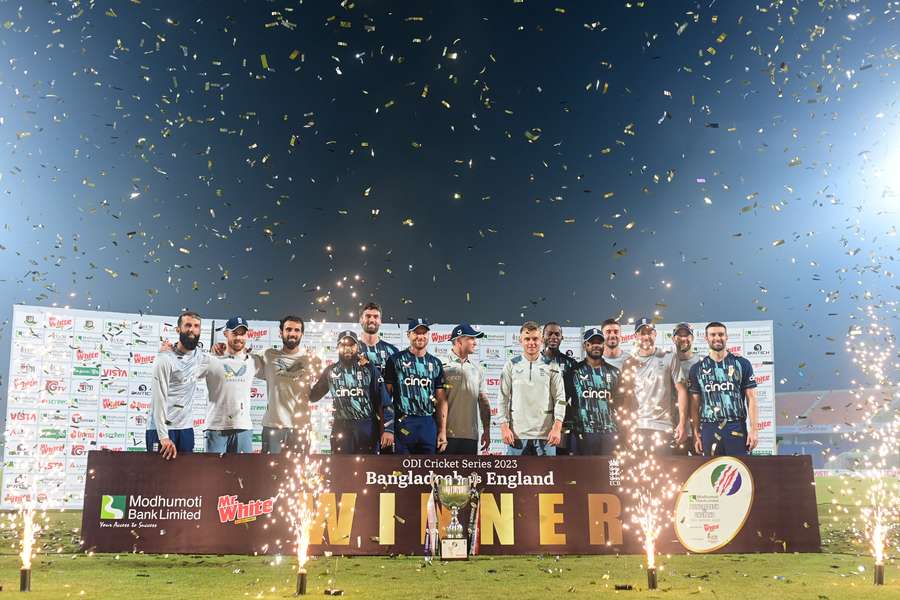 England's players pose with the tournament trophy