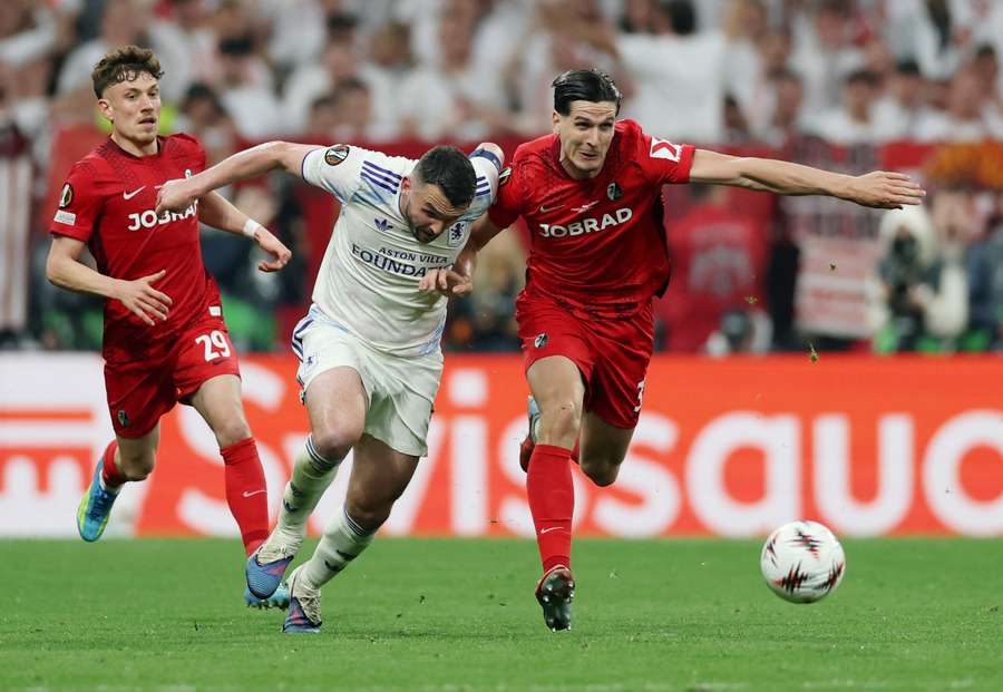 John McGinn and Igor Matanovic battle for the ball