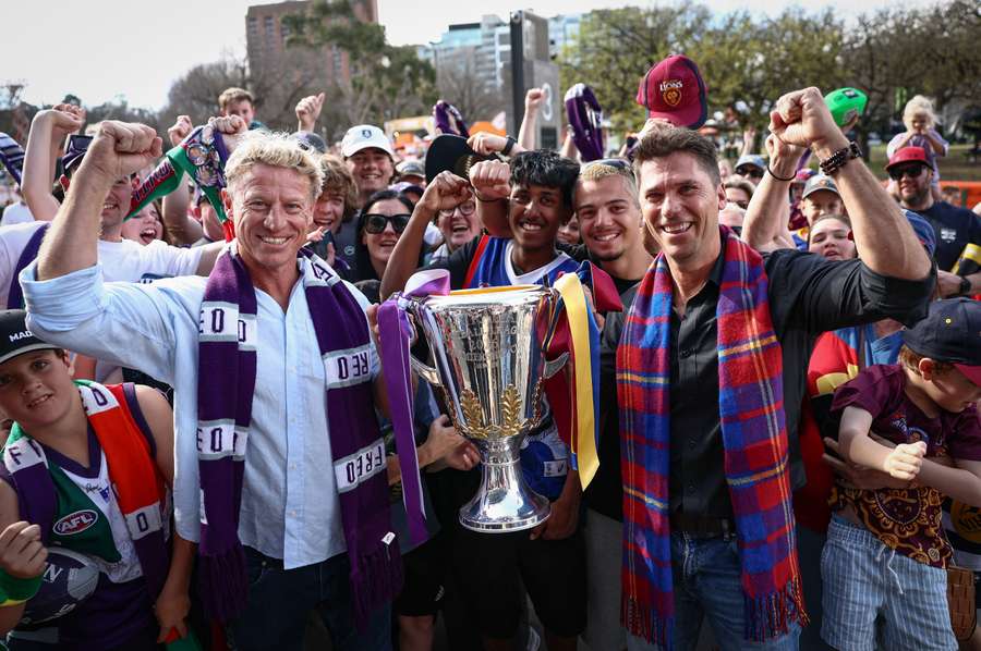Former Fremantle and Brisbane players Shaun McManus and Simon Black with the Premiership Cup in Melbourne on Thursday.