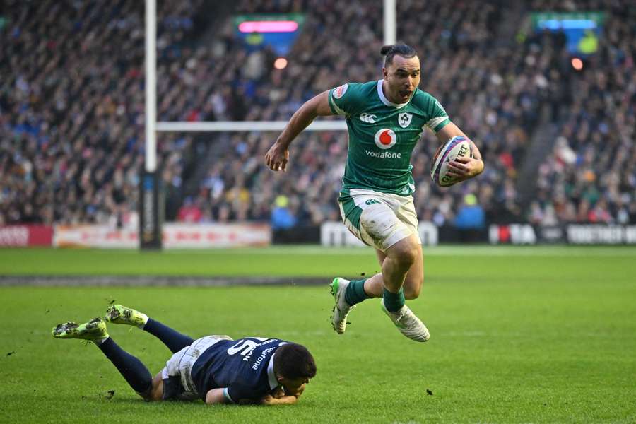 Ireland's James Lowe skips away from Scotland's Blair Kinghorn on his way to scoring a try 