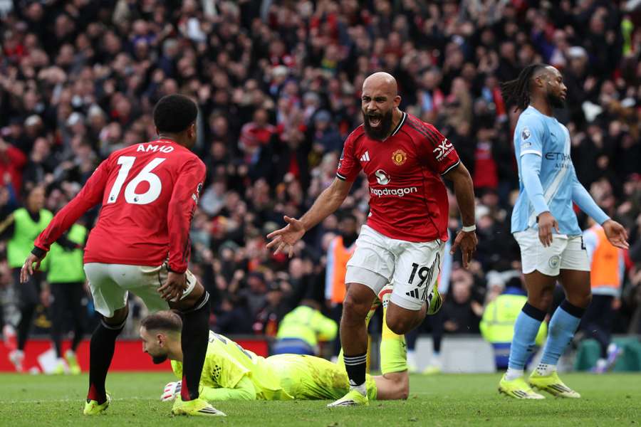 Manchester United's Bryan Mbeumo (C) celebrates with Amad Diallo (L) after scoring the opening goal
