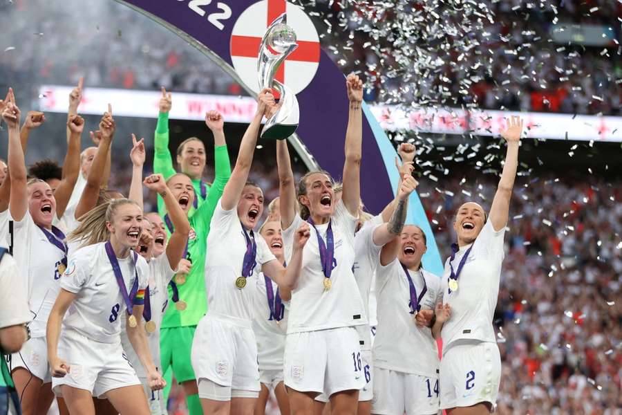 The England team celebrates gold