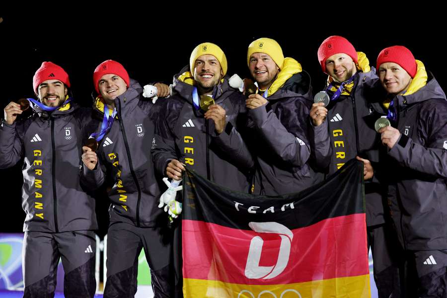 Germany's medalists celebrate after the two-man bobsleigh