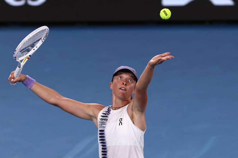 Iga Swiatek hits a shot against Anna Kalinskaya