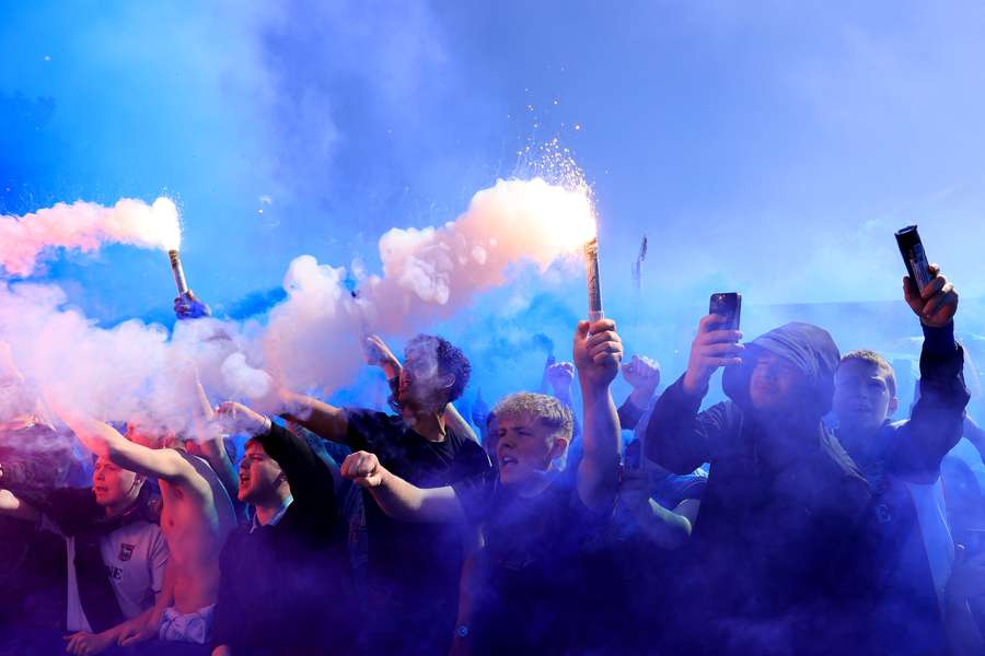 Fans of Ipswich Town show their support as flares are set off