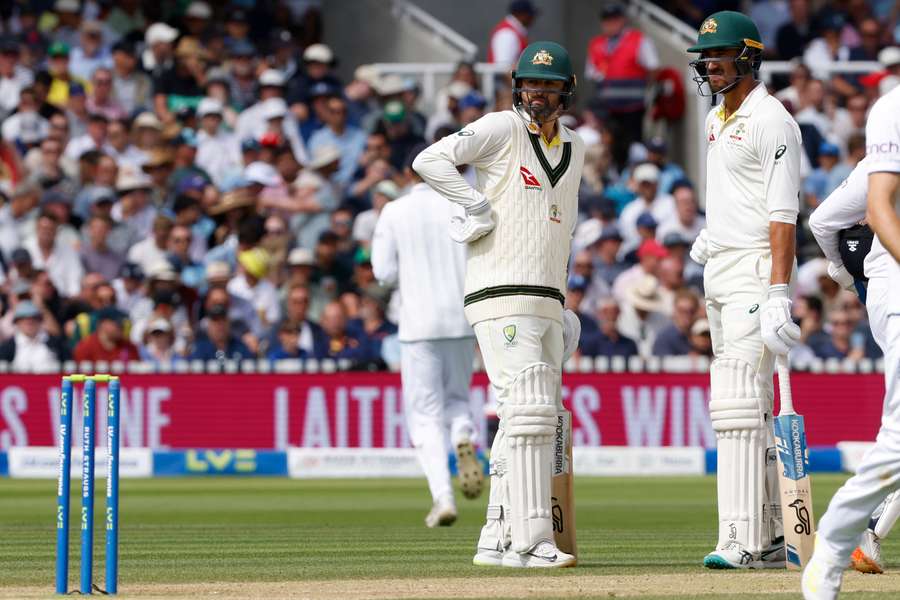 Australia's Nathan Lyon (L) at the crease despite being unable to run due to an injury