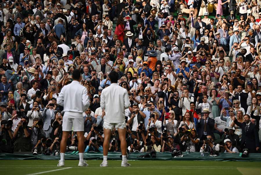Wimbledon finalists Novak Djokovic, left, and Carlos Alcaraz, right, pose for photos