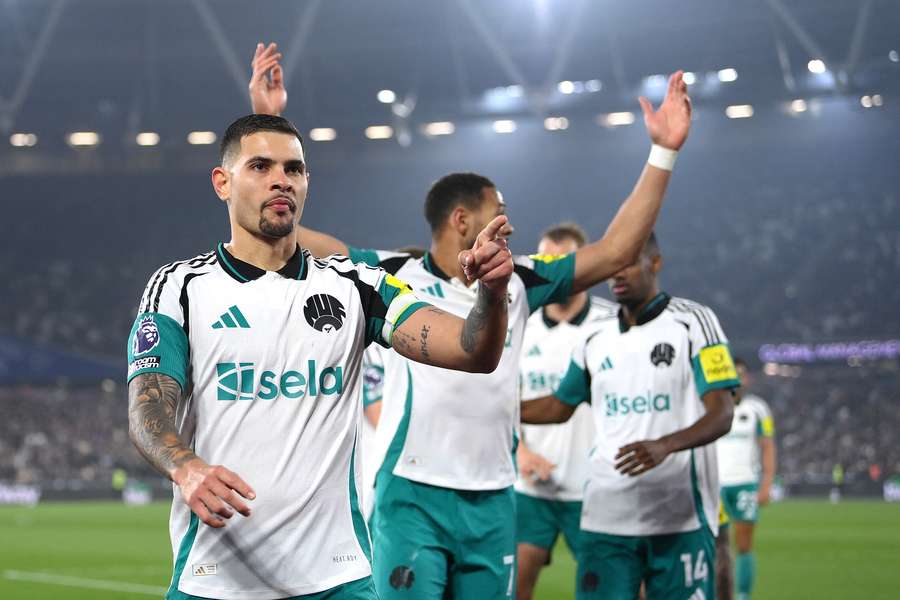 Bruno Guimaraes, left, celebrates his goal with Newcastle teammates