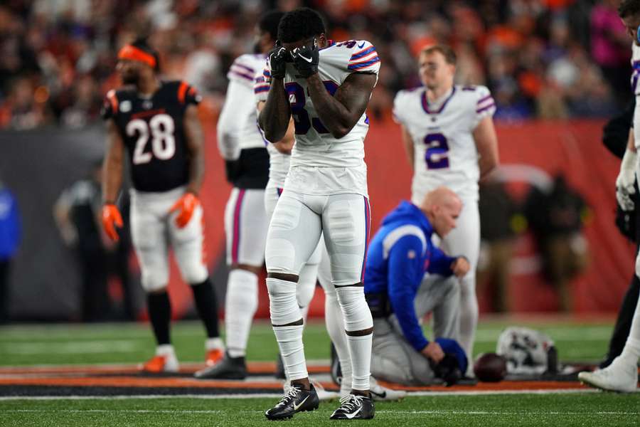 Bills' cornerback Siran Neal reacts as Damar Hamlin is tended to on the field and taken by ambulance