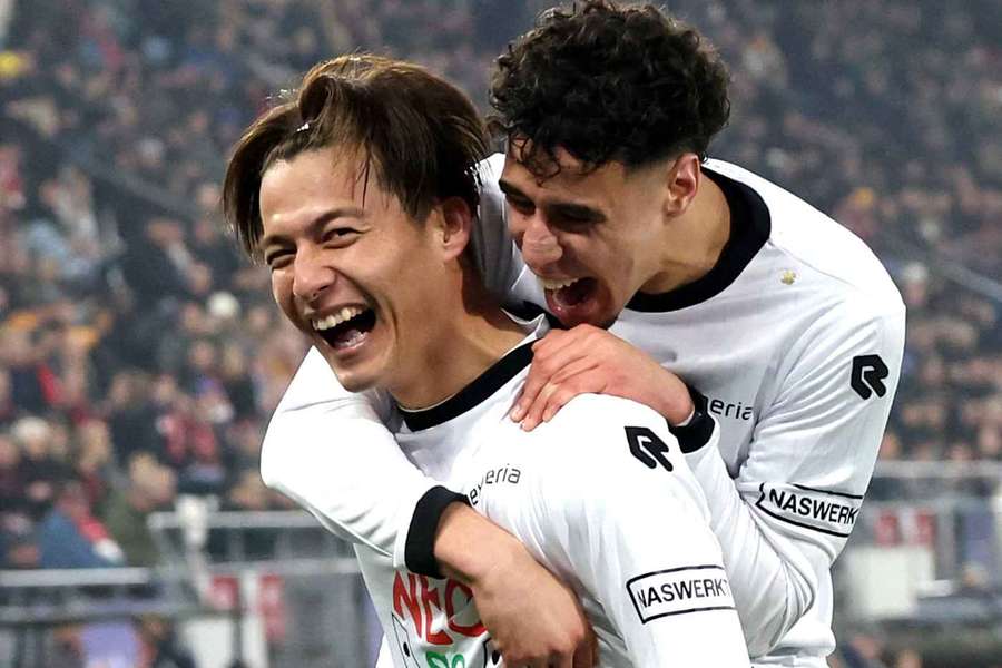 NEC's Kodai Sano (L) celebrates after scoring against AZ