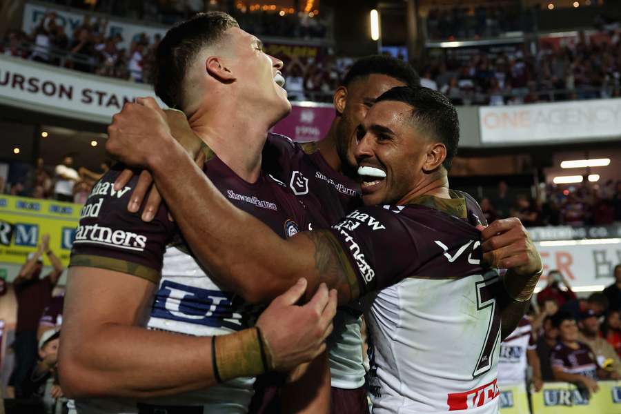 Manly Sea Eagles players celebrate the team's fourth consecutive win. 