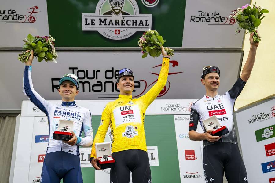 Joao Almeida (centre) celebrates on the podium alongside second-placed Lenny Martinez (left) and third-placed Jay Vine