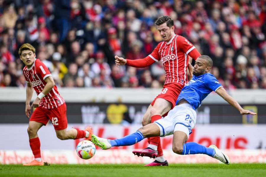 John Brooks and Michael Gregoritsch battle for the ball