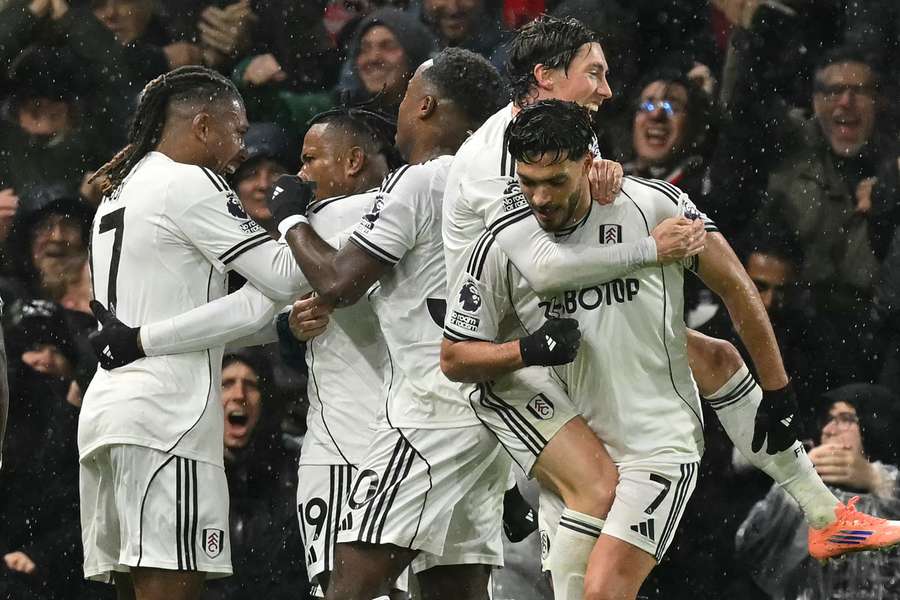 Fulham players celebrate after the match-winner