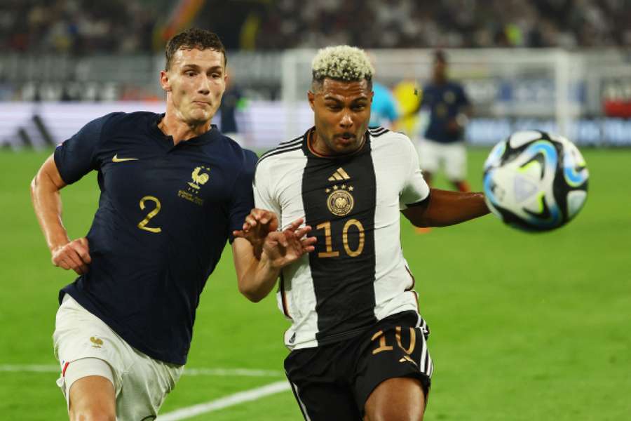 France's Benjamin Pavard in action with Germany's Serge Gnabry