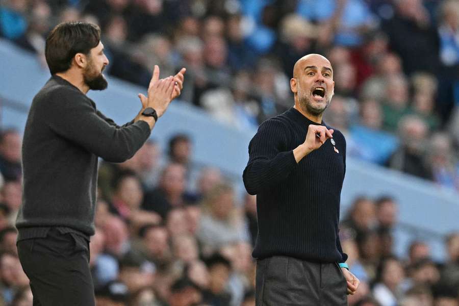 Pep Guardiola gestures on the sidelines next to Southampton's head coach Russell Martin