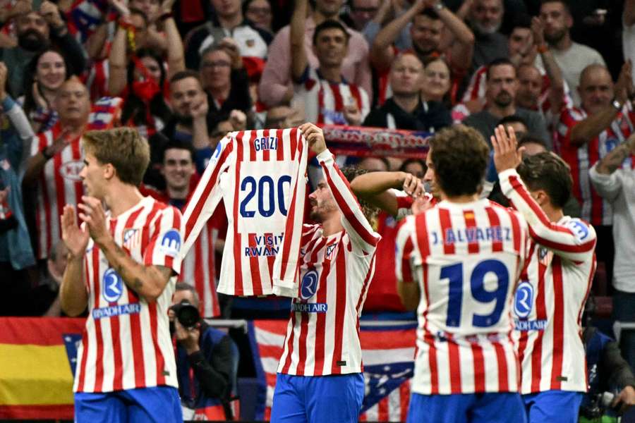Antoine Griezmann celebrates his landmark goal for Atletico Madrid
