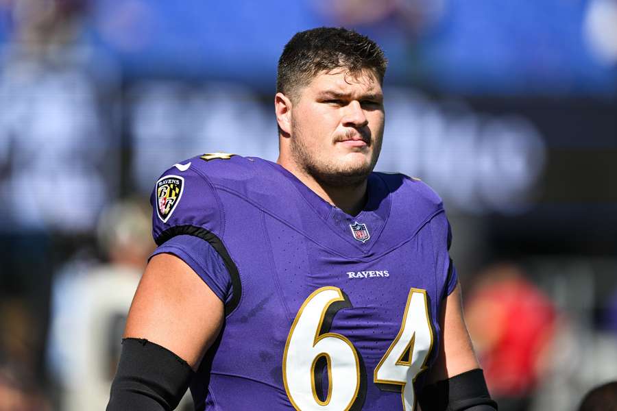 Ravens' Tyler Linderbaum looks on before a game
