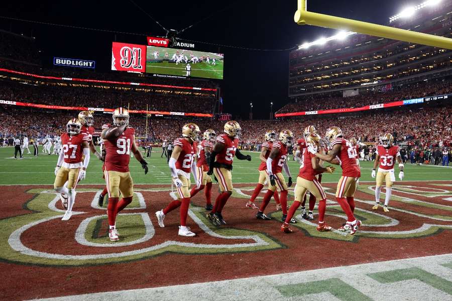 Arik Armstead of the San Francisco 49ers celebrates with teammates after recovering a fumble