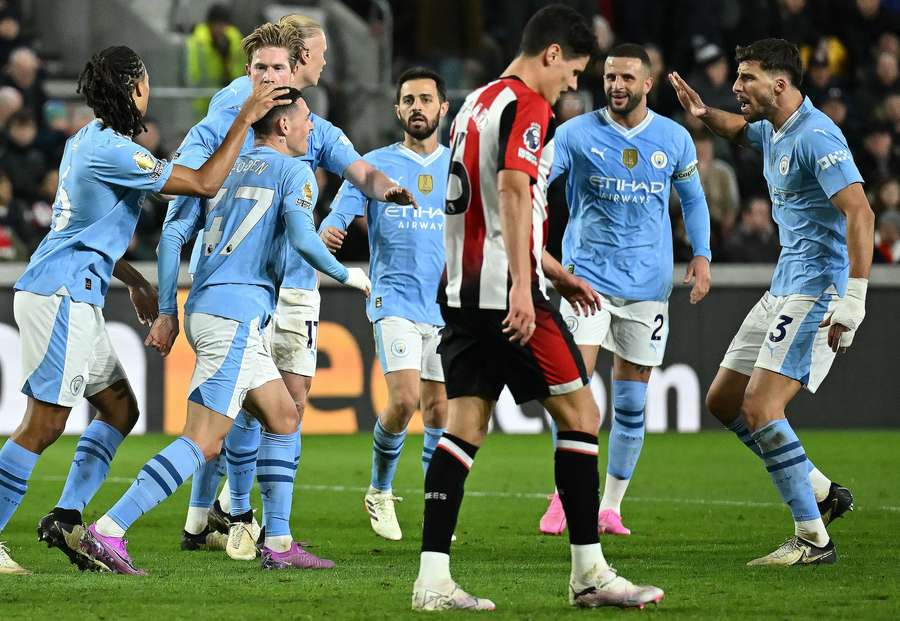 Phil Foden (2L) is mobbed by teammates after scoring the team's first goal
