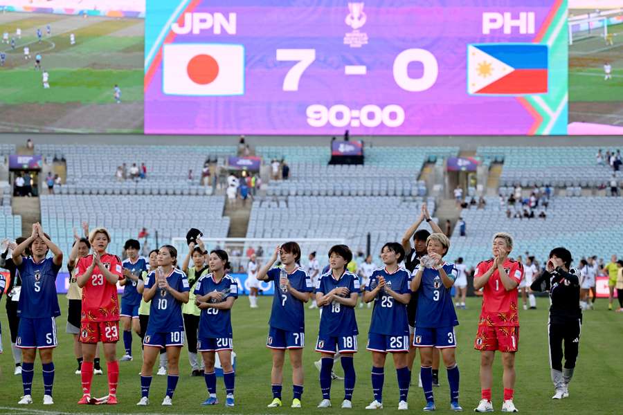 Japan's players celebrate their 7-0 victory