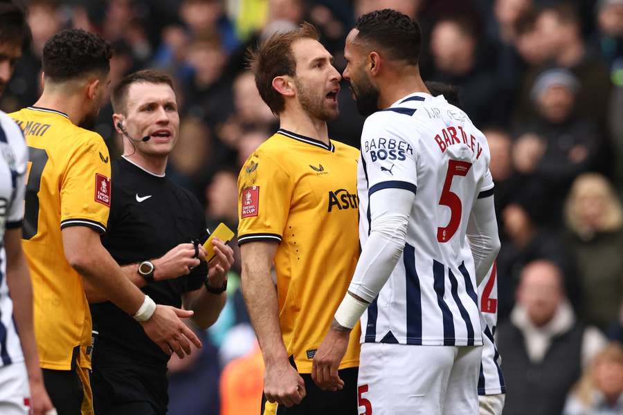 Wolverhampton Wanderers' English defender #15 Craig Dawson (C) clashes with West Bromwich Albion's English defender #05 Kyle Bartley (R) 