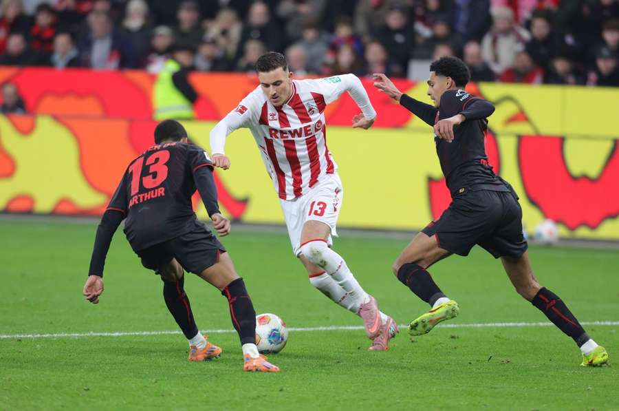 Said El Mala trying to search past Leverkusen's Arthur and Quansah Jarell