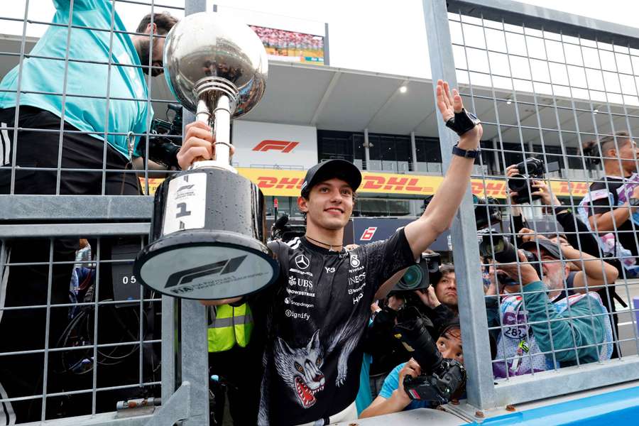 Kimi Antonelli celebrates with the trophy after winning the Japanese Grand Prix