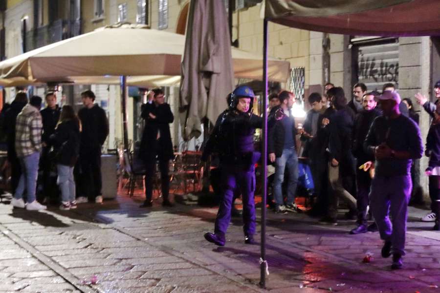 An Italian policeman works at the scene of a fight between PSG and AC Milan supporters