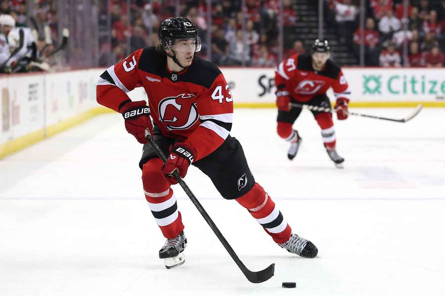 New Jersey Devils' Luke Hughes skates up ice with the puck (2025)