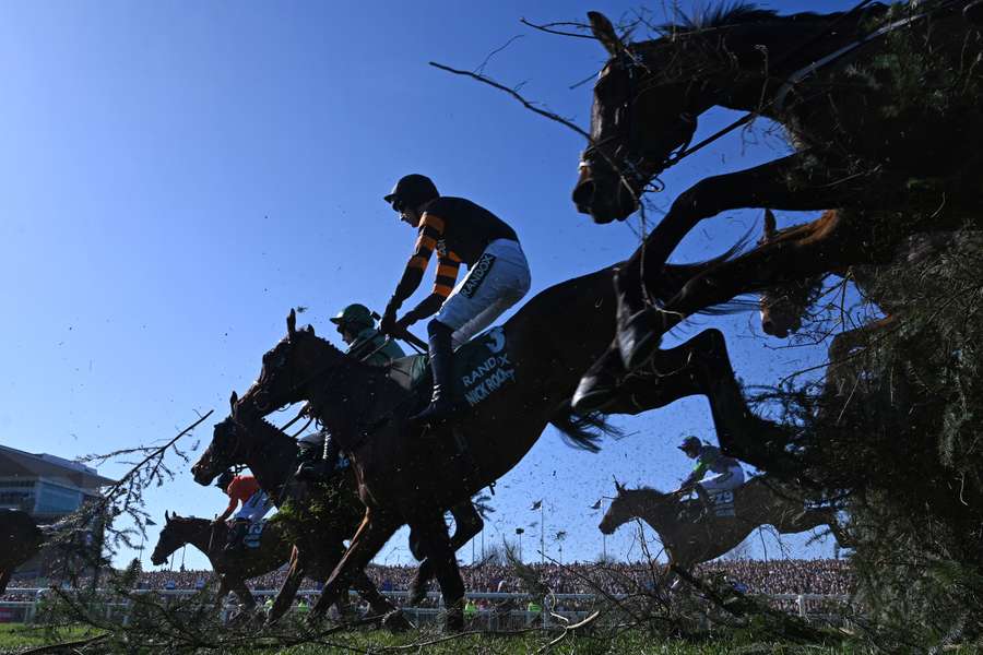 Jockey Patrick Mullins (c) jumps The Chair on Nick Rockett on the first circuit on the way to winning the Grand National Hanidap Chase
