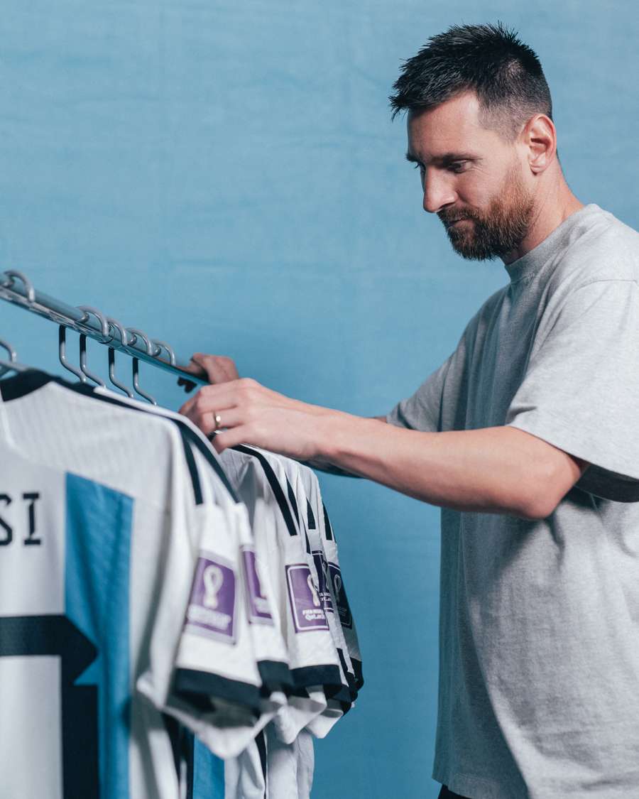 Lionel Messi browses through a set of six match worn shirts from the 2022 FIFA World Cup