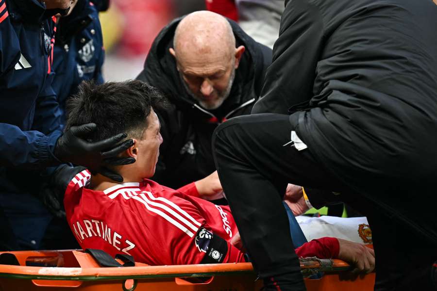 Lisandro Martinez reacts as he is evacuated on a stretcher after suffering an injury during Man Utd's defeat against Crystal Palace
